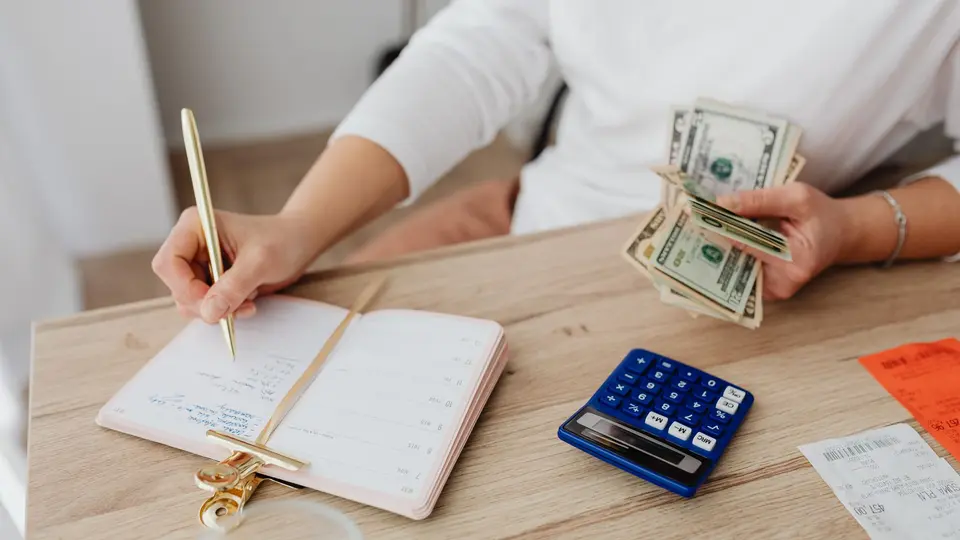 Clean desk with laptop displaying compound interest charts and notebook