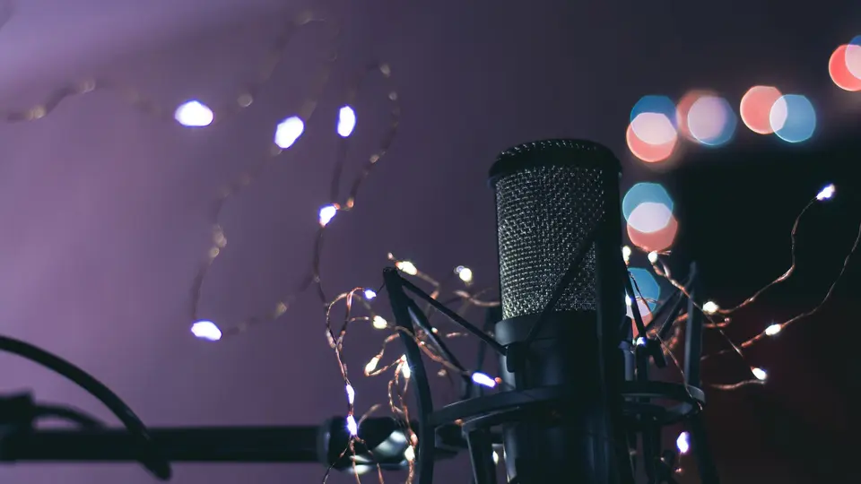 Independent creator studio with microphone, LED key lights, and dynamic monitor setup