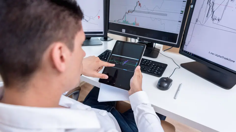 Savvy investor reviewing decentralized hard-asset portfolio on secure laptop