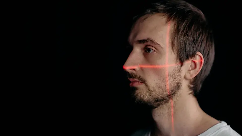 High-density digital facial recognition mesh grid overlaid across human portrait