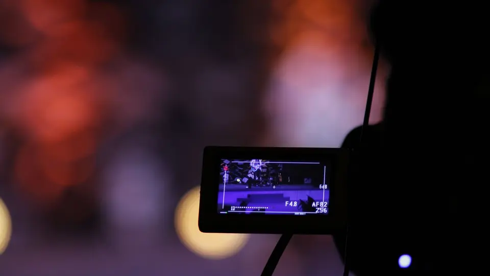 Forensic video verification lab analyzing microscopic pixel artifacts on suspicious video