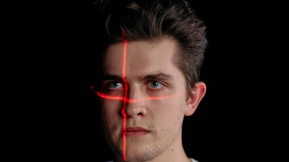 Futuristic digital face biometric wireframe glowing in dark matrix