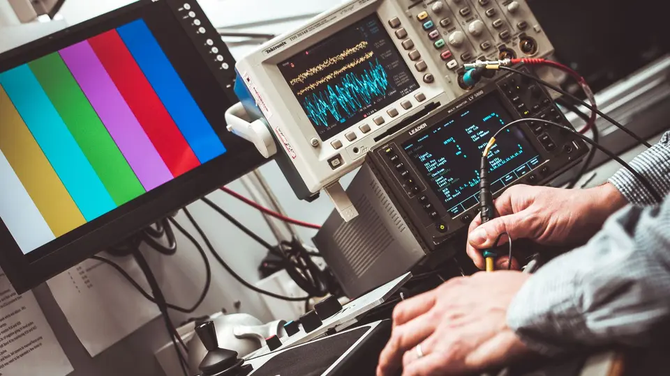 Advanced robotic arm manipulating electronics on high-tech assembly line