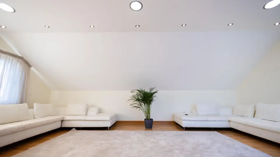Sun-drenched living room with zero visual clutter, single reading chair, and open view
