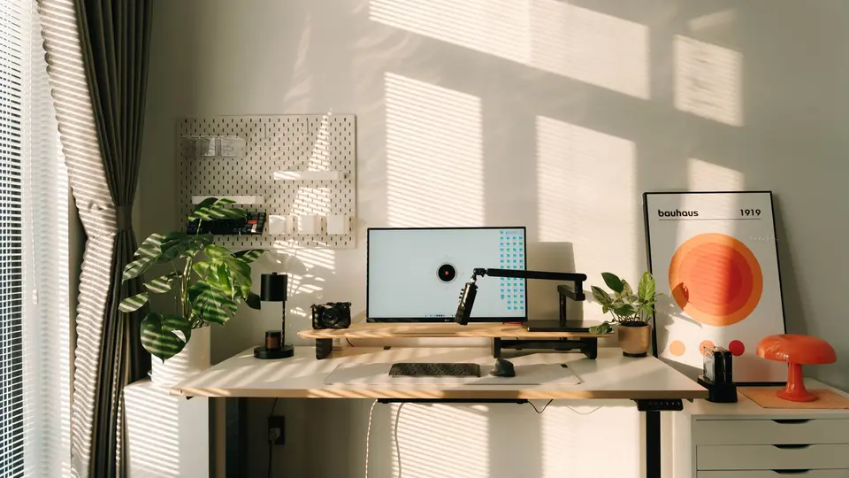 Dual screen workstation showing analytics, sleek keyboard, and modern coffee mug