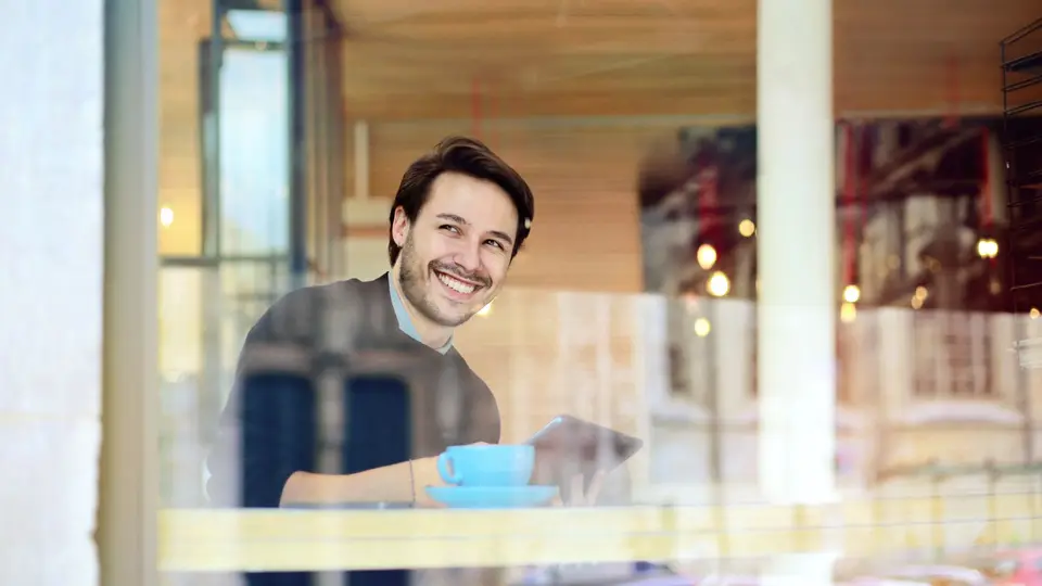Confident individual celebrating career milestone in modern loft apartment