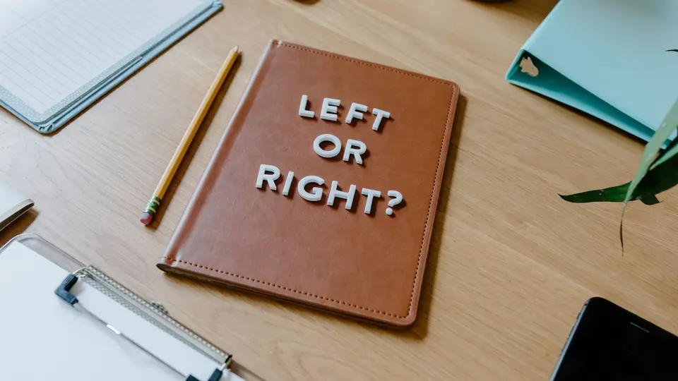 Leather portfolio, resume paper, and sleek pen on polished interview table