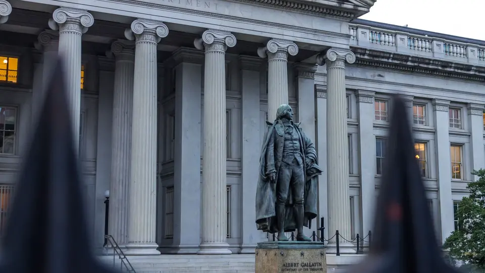 Towering neoclassical stone columns and bronze doors of national central bank building