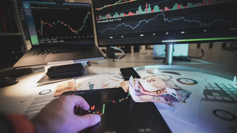 Savvy investor reviewing decentralized hard-asset portfolio on secure laptop