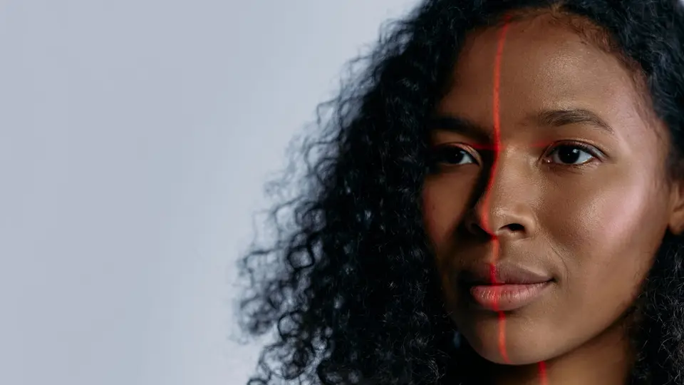 High-density digital facial recognition mesh grid overlaid across human portrait