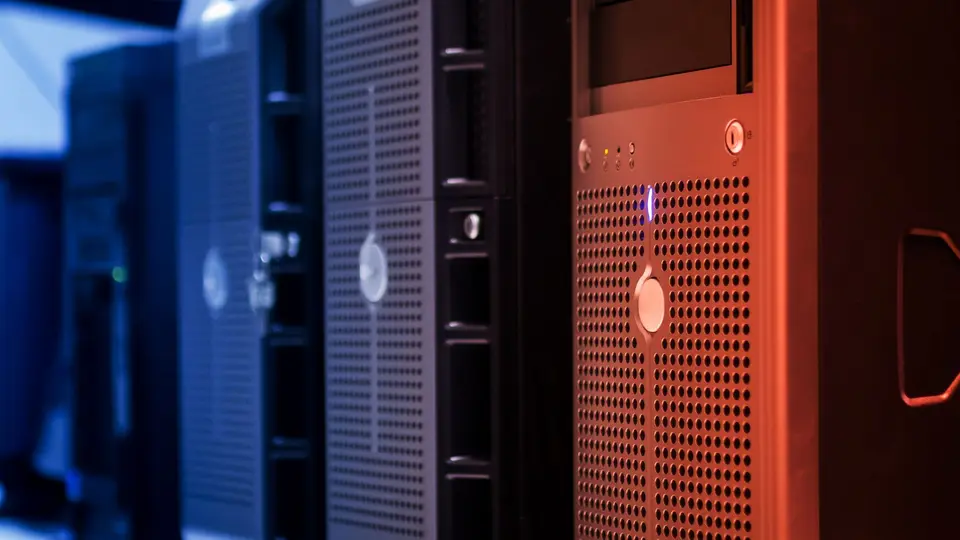 Underground server room with flickering red warning lights and severed cables