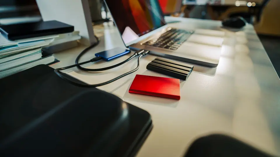 Mysterious glowing USB drive plugged into laptop in dimly lit room