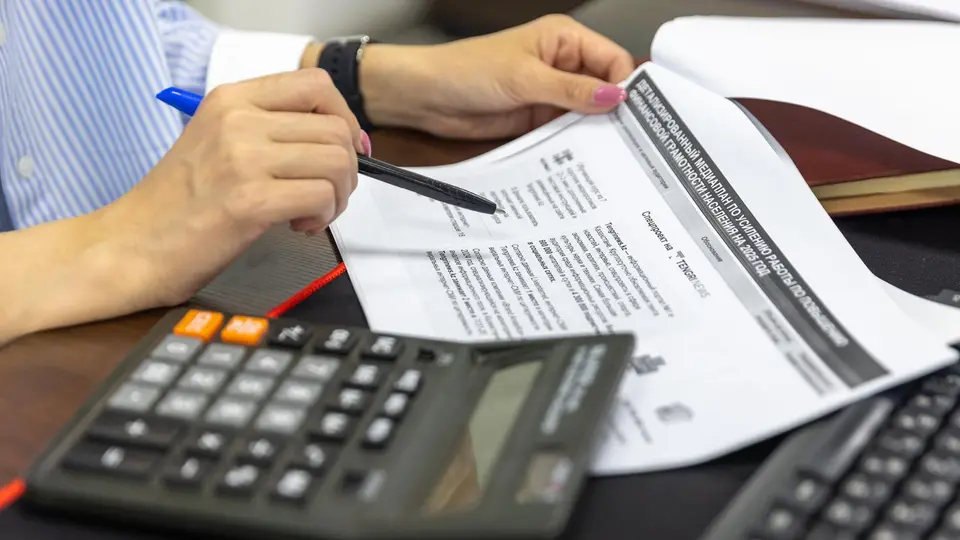 Clean desk with financial documents and subtle professional accounting background