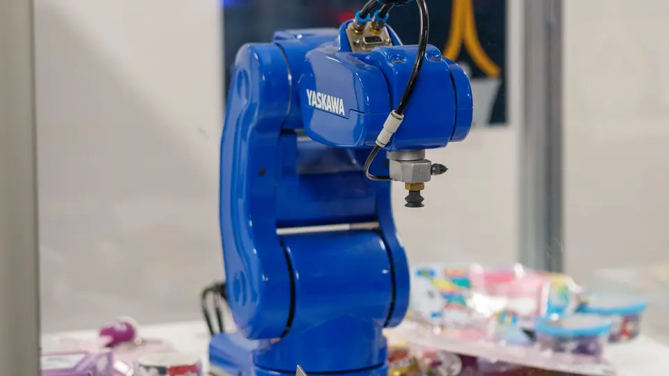 Advanced robotic arm manipulating electronics on high-tech assembly line